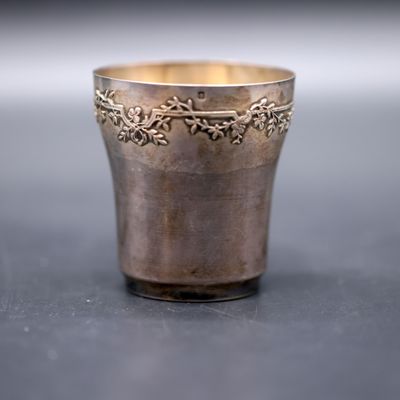 a silver cup that is sitting on a table