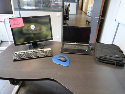 a desk with two computers and a mouse on it