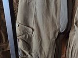 a pair of pants hanging on a rack in a room