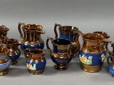 many different types of blue and gold vases on the table