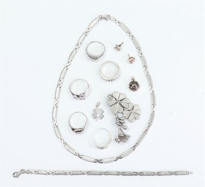 an image of a collection of rings and bracelets on a white surface