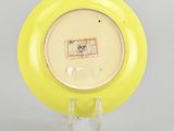 an image of a yellow plate with a picture of a cat on it