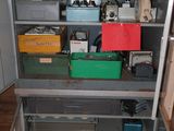 a metal cabinet with many different items in it
