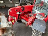 an image of a red tractor parked in a garage