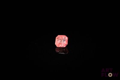 une image représentant un rocher rose dans l'obscurité, sur fond noir