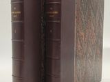 deux livres bruns posés l'un sur l'autre sur une surface blanche