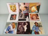 several cd ' s of marilyn monroe are on display on a table