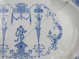 a blue and white plate with a design on it