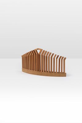 a wooden comb on a white surface with a white background