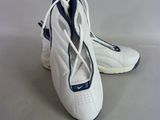 a pair of white and blue shoes on a table