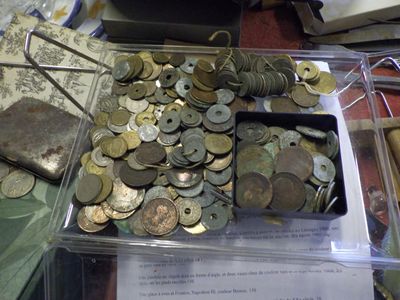 a lot of coins in a container on a table