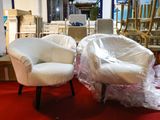 two chairs that are wrapped in plastic on a red carpet