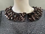 a close up of a woman ' s dress with buttons on it