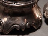 two silver salt and pepper shakers sitting on a table