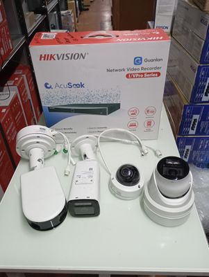 three cameras sitting on a table in front of a box