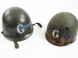 two military helmets with the letters g and g on them