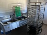 a kitchen with a sink and a rack in it