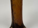a vase with a painting on it sitting on a table