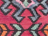 a close up of a colorful rug with a design on it