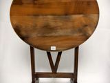 an old wooden table with a round top on a white background