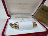 a red box with a silver and gold bracelet inside of it