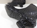a pair of black shoes that are on a table
