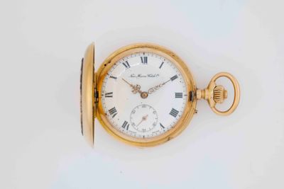 an old gold pocket watch with roman numerals and roman numerals on the face