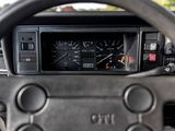 a steering wheel and dashboard of a car with a clock on it