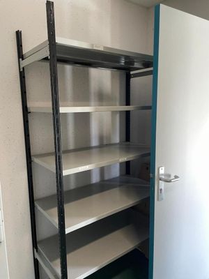 a metal shelf with shelves in the corner of a room