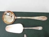 two spoons and a ladle on a table