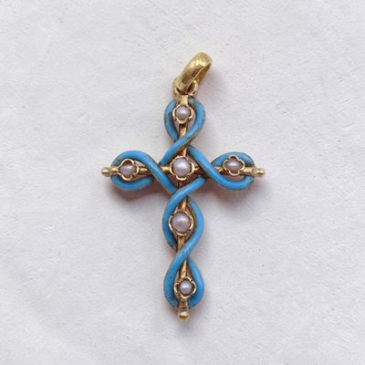 a close up of a cross on a white surface