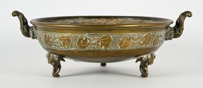 an old bronze bowl with handles and handles on a white background