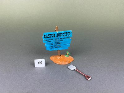 a small toy boat with a sign on the side of it