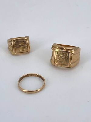 two gold rings and a gold ring with a small gold ring on it