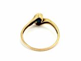 a close up of a gold ring with a blue stone