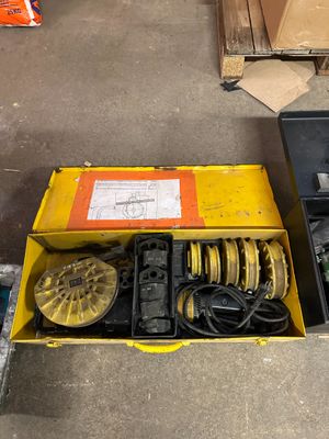 two boxes of tools sitting on the floor next to each other