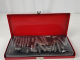 an open red case with a bunch of tools inside of it