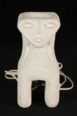 a white ceramic sculpture of a person with a face on it