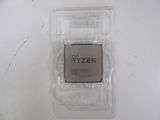 an amd ryzen cpu in a plastic box on a white surface