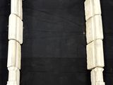 a pair of white marble columns on a black background