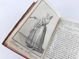 an open book with a drawing of a woman in a long dress holding a wand