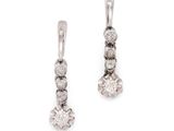 a pair of diamond earrings on a white background