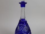 an image of a blue glass decanter on a white background