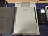 une tablette posée sur un bureau, à côté d'un clavier