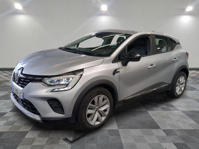 a silver car is parked in a room with checkered flooring