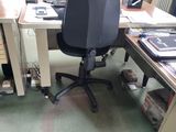 a desk with a chair and a computer on it