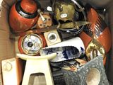 a cardboard box filled with assorted items including a clock and other items