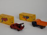 three toy trucks sitting next to each other on a white surface