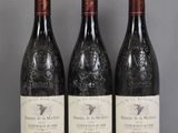 three bottles of wine are sitting on a glass table