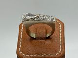a close up of a silver ring on a brown leather box